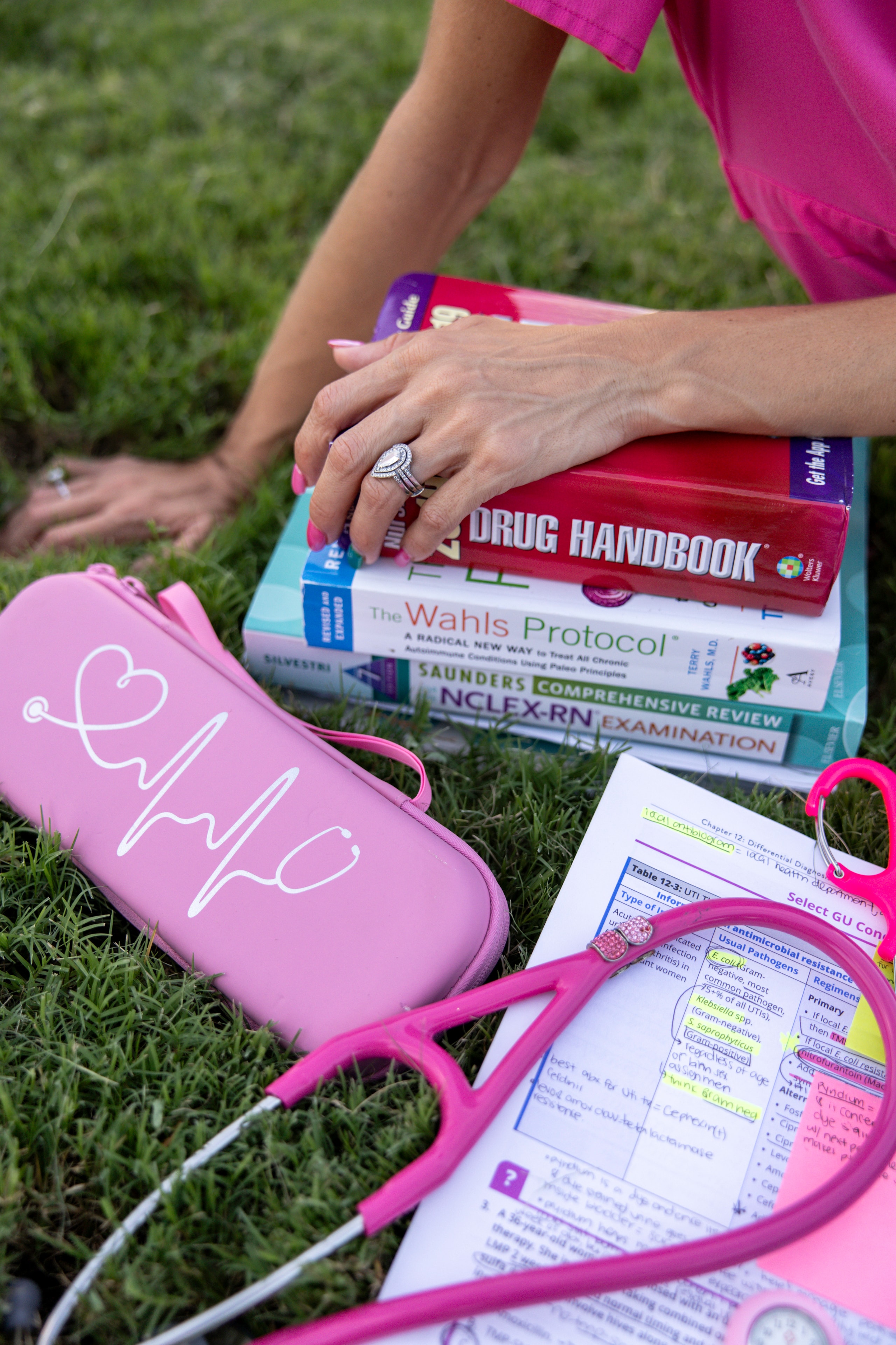 Camille studying nursing textbooks and notes outdoors